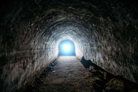 Tunnel with concrete walls in old abandoned Soviet bunker.の写真素材