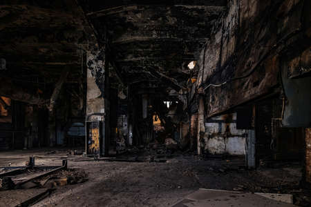 Burnt and ruined interior of industrial building after fire. Consequences of war, fire or other disaster.の写真素材