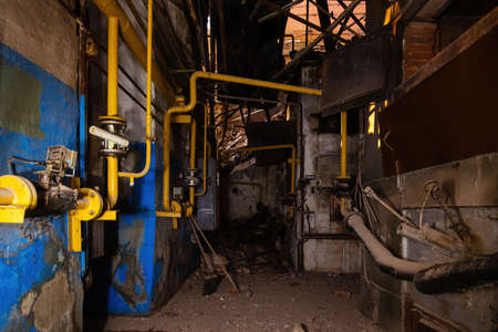 Inside old collapsed industrial building. Old rusty pipeline.の写真素材