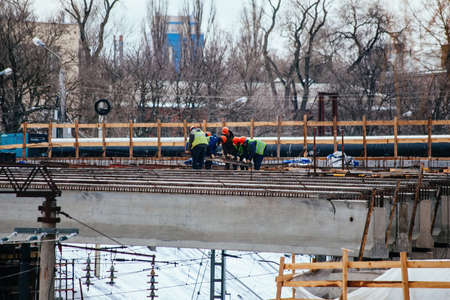 Workers in protective helmets are repairing bridge in Voronezh.の写真素材