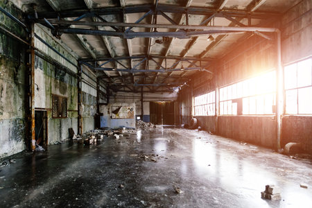 Old abandoned large industrial hall. Empty warehouse.