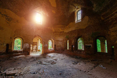 Dark corridor of old ancient abandoned red brick ruined historical building.の写真素材