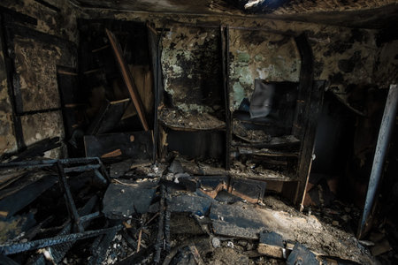 Burnt wooden house interior. Consequences of fire.の写真素材
