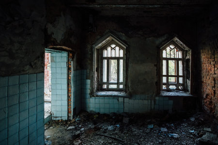 Inside old ruined abandoned historical mansion in Gothic style.