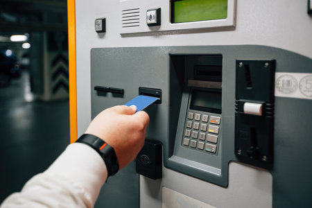 Man pays for underground parking using payment terminal.
