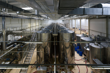 Modern winery production line. Storage vats and bottling equipment.