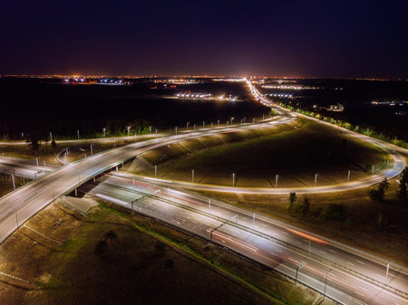 Highway road junction at night, aerial view.