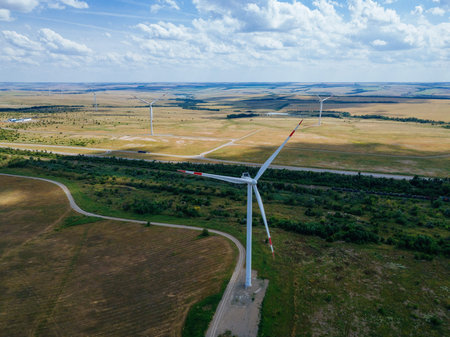 Wind turbines at the countryside in summer day, aerial view.