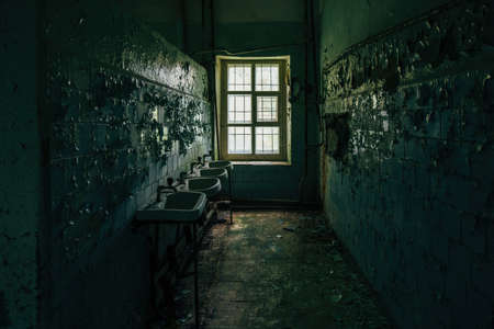 Inside old Asylum for the insane. Dark creepy abandoned mental hospital.の写真素材