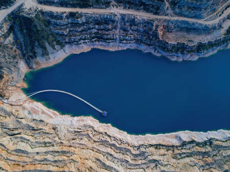 Abandoned limestone quarry with lake at the bottom.の写真素材