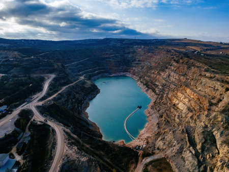 Abandoned limestone quarry with lake at the bottom.の写真素材