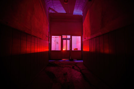 Dark and creepy corridor of old abandoned mental hospital at night.