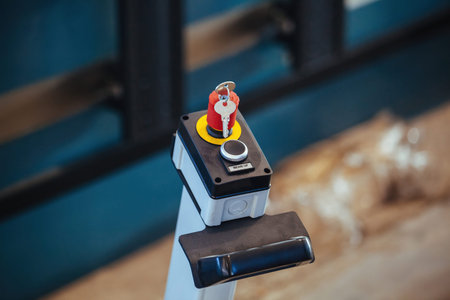 Key switch and start button of industrial machinery, close up.