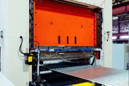 Modern roll forming machine in metal profiling workshop.の写真素材