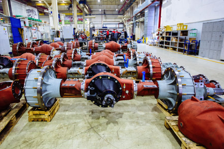 New axles and other spare parts for cars, trucks or tractors in the workshop.