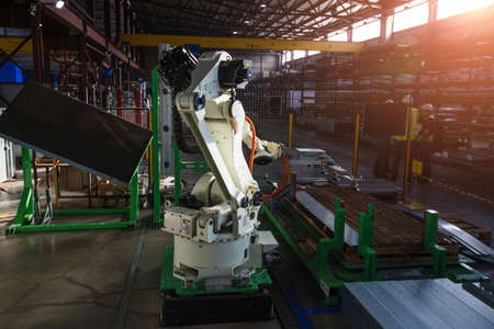 Robotic arm working with metal sheet.の写真素材