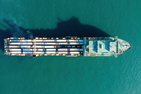 Cargo ship with containers and trucks, directly above drone view