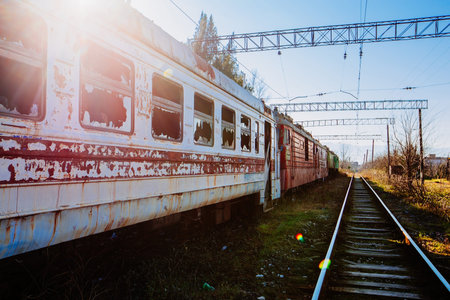 Old abandoned broken high speed train on railway.