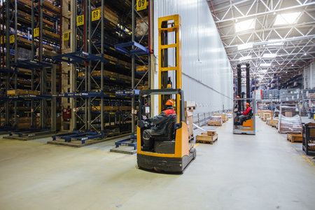 Forklift loader in Modern warehouse interior with shelves and boxes.の写真素材