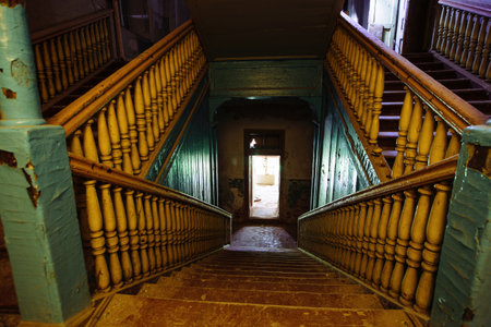 Old wooden staircase in dark abandoned mansion.の写真素材