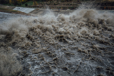 Spillway in Maykop dam, dirty water in river.の写真素材