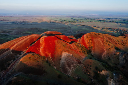 Dawn on beautiful landscape of layered striped red mountains in Georgia.の写真素材