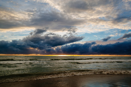 Sunset or dawn on sea. Dramatic cloudy sky.の写真素材