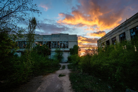 Old abandoned industrial area waiting for demolition at sunset.の写真素材