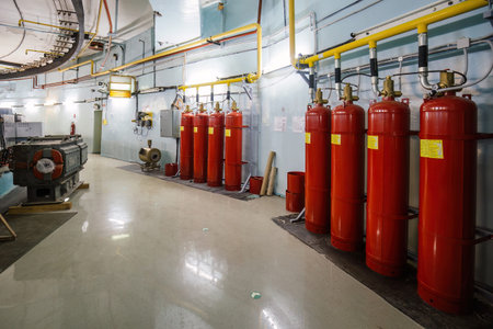 Automatic industrial fire extinguishing system. CO2 fire extinguishers connected with pipeline.