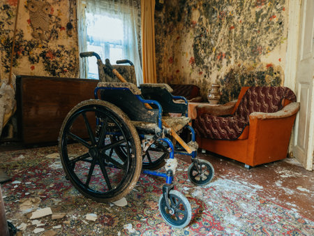 Empty wheelchair in old abandoned house.の写真素材