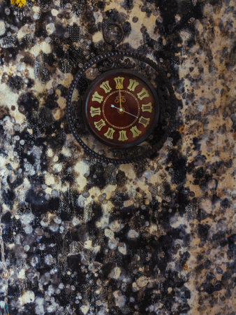 Old wall clock on wall with mold.の写真素材