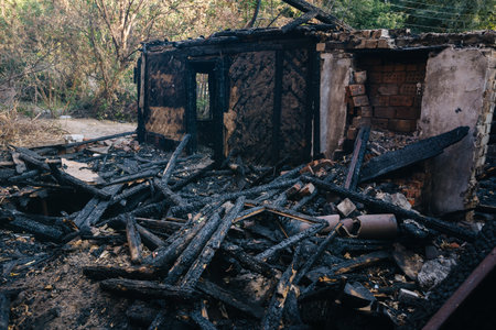 Consequences of fire. Completely burnt wooden house.の写真素材