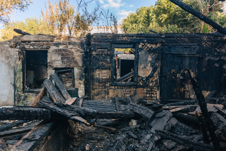 Consequences of fire. Completely burnt wooden house.の写真素材