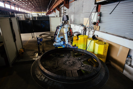 Industrial robot is welding metal machine part.