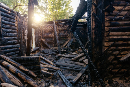 Consequences of fire. Completely burnt wooden house.の写真素材