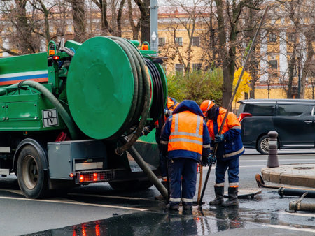 Sewer workers cleaning manhole and unblocking sewers.の写真素材