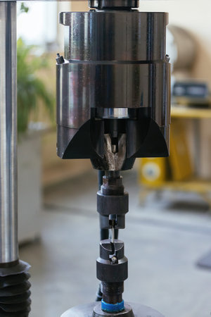 Modern laboratory equipment for testing of steel material. Press for testing metal sample.