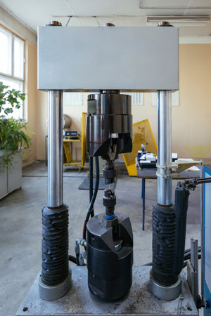 Modern laboratory equipment for testing of steel material. Press for testing metal sample.の写真素材