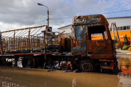 Burnt truck on flooded road. Fire or attack aftermath.の写真素材