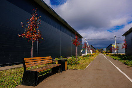 Modern industrial buildings and autumn foliage.