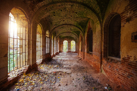 Corridor of old ancient abandoned red brick ruined historical building.の写真素材