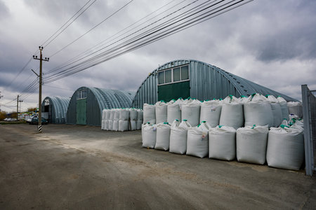 Industrial warehouses with round roof and plastic bags with goods.の写真素材