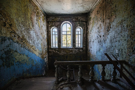 Old abandoned building. Walls with peeled paint.