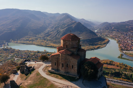 Drone aerial view of Jvari monastery and the mountains in Mtskheta, Georgia.
