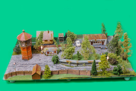 Handmade model of a city landscape on a green background.の写真素材