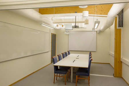 Modern conference / meeting room isolated. White office table and blue chairs. Business concept. Modern office style.の写真素材