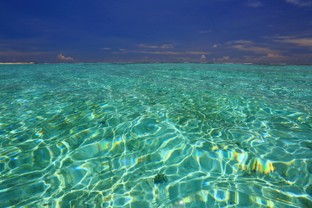 Amazing view on horizon line. Turquoise water surface and skyline with white clouds. Gorgeous nature background. maldives. Indian Ocean.の写真素材