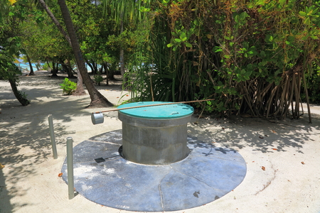 Close up view of an old water. Green trees on background. Maldives.の写真素材