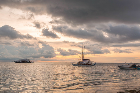 Gorgeous view of sunset on Indian Ocean, Maldives. Some boats on horizon line. Amazing nature landscape background.の写真素材