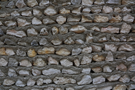 Texture of gray stone wall. Gray stone wall and cement solution as background or texture.の写真素材
